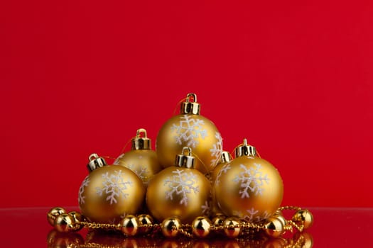golden christmas balls of red background