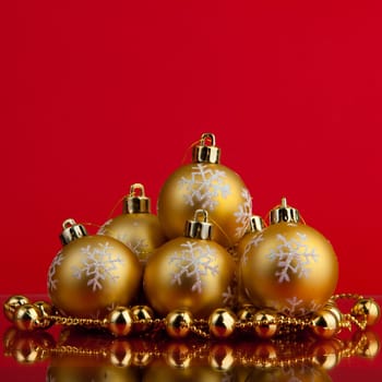 golden christmas balls of red background