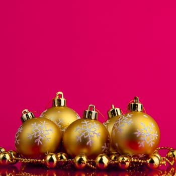 golden christmas balls of red background