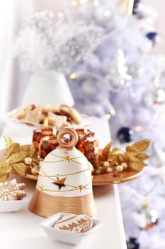 Christmas decoration with the bell and Christmas tree in background