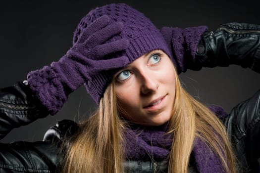Woman with leather jacket,hat,scarf and gloves