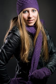 Woman with leather jacket,hat,scarf and gloves