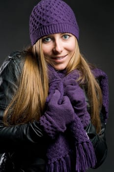 Woman with leather jacket,hat,scarf and gloves