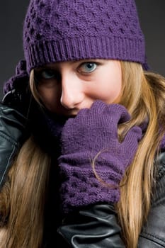 Woman with leather jacket,hat,scarf and gloves