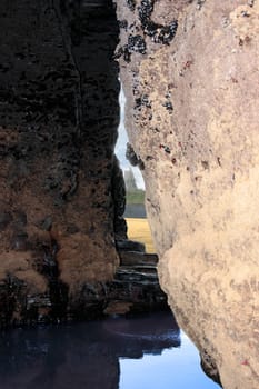 a view of ballybunion castle as seen from a cliff cave