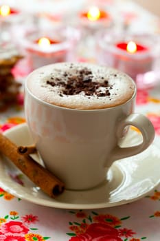 Close-up of delicious hot chocolate with chocolate sprinkles and cinnamon sticks