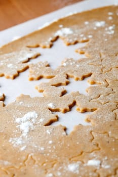 Making gingerbread cookies for Christmas. Gingerbread dough with star shapes.