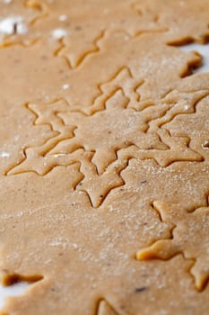 Making gingerbread cookies for Christmas. Gingerbread dough with star shapes.