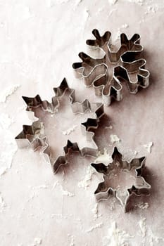 Close-up of metallic gingerbread cutters, star shape and snowflake