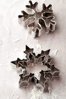 Close-up of metallic gingerbread cutters, star shape and snowflake