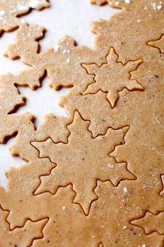 Making gingerbread cookies for Christmas. Gingerbread dough with star shapes.