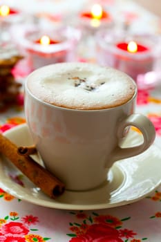 Close-up of delicious hot chocolate with chocolate sprinkles and cinnamon sticks