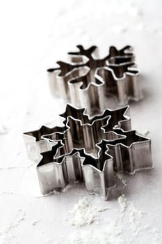 Close-up of metallic gingerbread cutters, star shape and snowflake