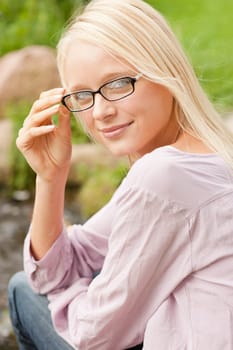 Portrait of a young and smiling woman in the park