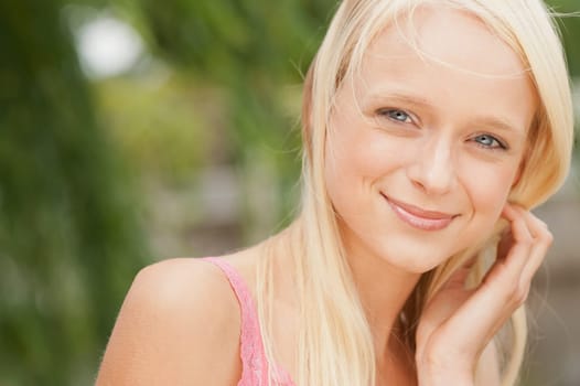 Portrait of a young and smiling woman in the park