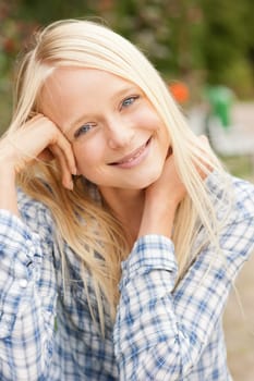 Portrait of a young and smiling woman in the park