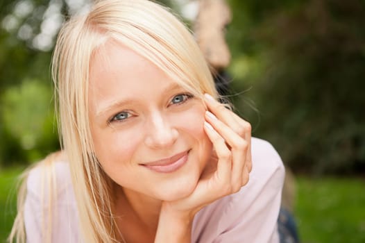 Portrait of a young and smiling woman in the park