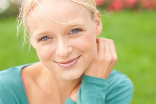 Portrait of a young and smiling woman in the park