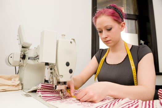 Young seamstress working on a sewing machine
