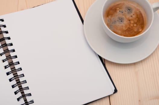 Notebook and Espresso Coffee on Wooden Table