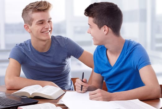 Two young guys working together to study the Bible