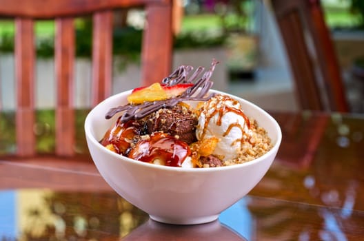 ice cream with chocolate, nuts and caramel close up