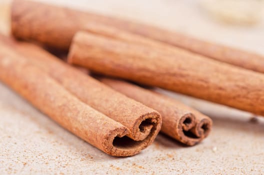 Cinnamon stick closeup on a brown background