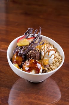 ice cream with chocolate, nuts and caramel close up