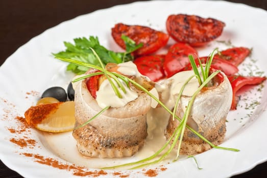 fillet of pikeperch stuffed with trout fish with baked pepper, tomato and leek