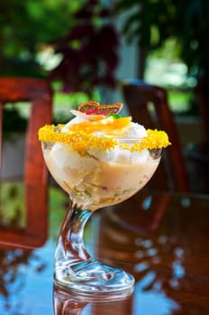 Ice cream dessert with kiwi and orange decorated with butterfly