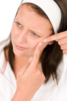 Acne facial care teenager woman squeezing pimple on white
