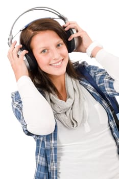 Smiling female teenager enjoy music with headphones and baseball cap