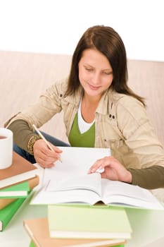 Student teenager happy girl write homework with book