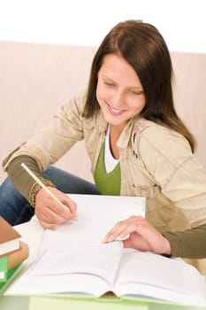 Student teenager happy girl write homework with book