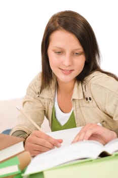Student teenager happy girl write homework with book