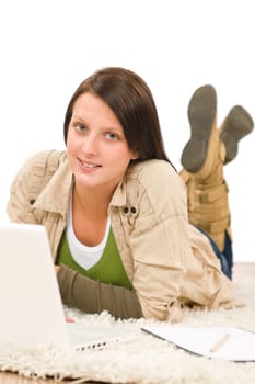 Student teenager happy girl typing laptop lying floor on carpet