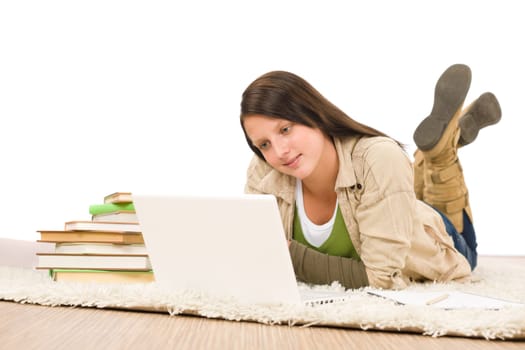 Student teenager happy girl looking laptop lying floor on carpet