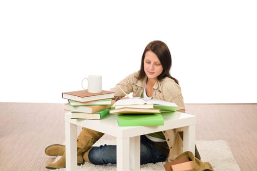 Student girl studying home sitting on floor with books