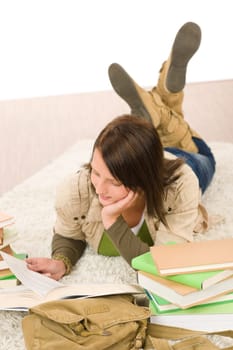 Student female teenager read homework with book on white background