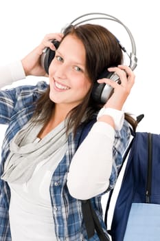 Smiling female teenager enjoy music with headphones and baseball cap