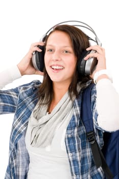 Smiling female teenager enjoy music with headphones and baseball cap