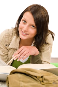 Student - female teenager write homework with book on white background
