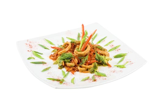 Seafood salad with squid and vegetables closeup