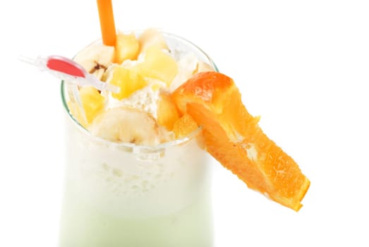 milk fruit cocktail with slice of orange cream and pipe
