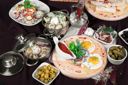Many food dishes on the restaurant table. close up.