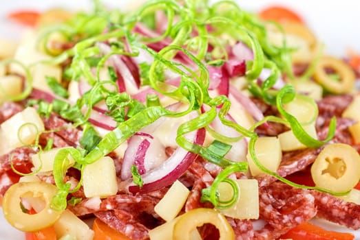 closeup of salad from salami, vegetables and olives