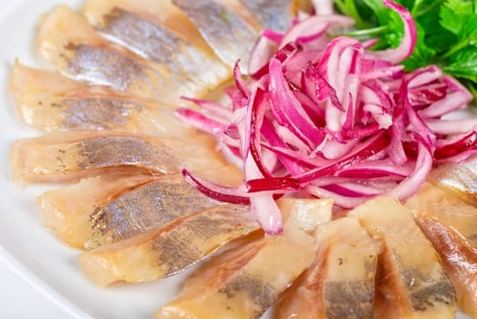 Marinated herring fillets closeup with onion