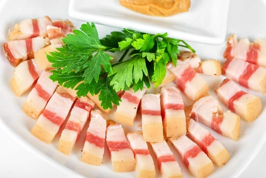 Sliced pig lard with greens closeup