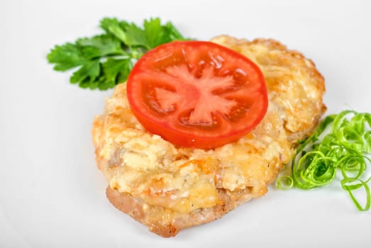 Roasted pork steak baked with cheese and tomato