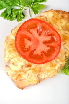 Roasted pork steak baked with cheese and tomato